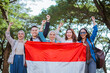 © Odua Images - young students holding indonesian flag celebrating independence day with raised fist