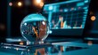 © Wonder Photo - A crystal ball sits on a desk, reflecting data charts from a laptop screen, symbolizing market analysis, future prediction, business insights, financial planning, and technological advancement.