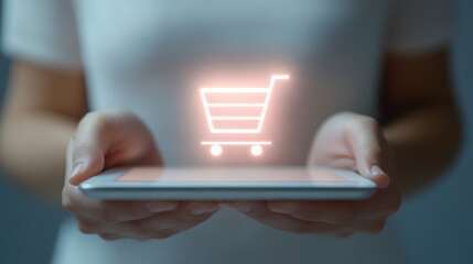 A woman is holding a tablet with a shopping cart on it