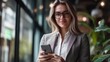 © Bijac - portrait of confident businesswoman using smartphone professional attire and modern office backdrop represents connectivity and mobile productivity in workplace
