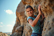 © Gianpiero - A smiling young woman enjoys rock climbing on a sunny day, showing excitement and adventure in nature. Captures a sense of freedom and challenge