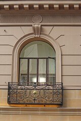 Wall Mural - Historic arched window with an ironwork balcony