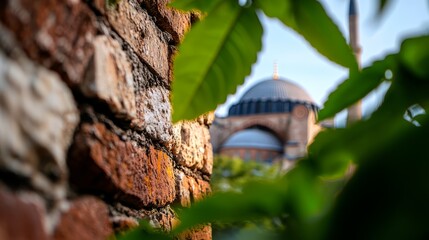 Wall Mural -  A tight shot of a brick wall with a structure looming in the distance and a tree covered in foliage in the front