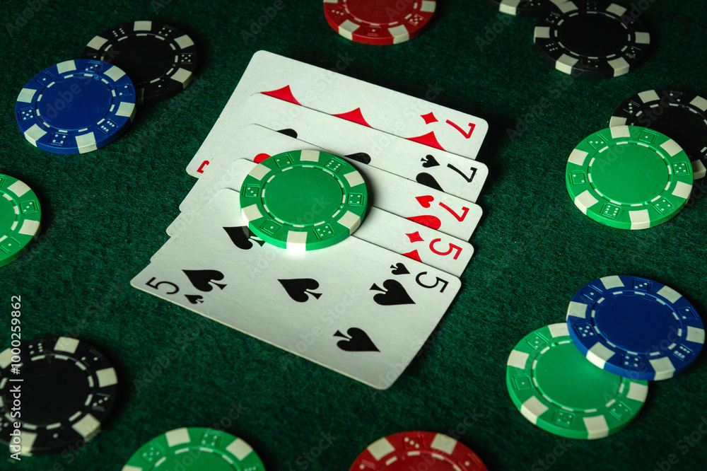 Chaotic game environment on a poker club table with a combination of full house or full boat cards and chips. Big win depends on luck