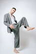 © Elina Leonova - Fashion man model in grey suit, barefoot, shoot in studio