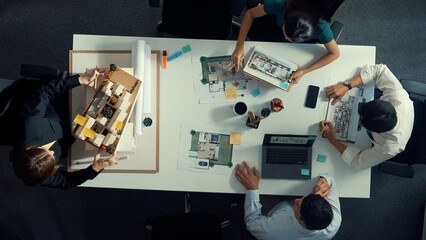 Top aerial view of project manager or civil engineer writing at blueprint and planning building design. Aerial view of architect working together at meeting table with document placed. Alimentation.