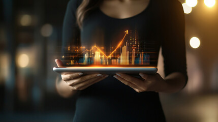 Leinwandbilder - Businesswoman is holding a tablet displaying a growing financial chart, symbolizing business success