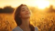 © atar - Woman with closed eyes enjoying warm sunlight in field. Relaxation, peace, and freedom concept.