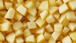 © Ice Cream Paradise - a close-up, top-down view of diced pears spread across the entire frame, filling the image with their pale yellow color and smooth texture in uniform cubes
