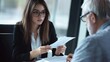 © 为轩 张 - Young businesswoman holding a paper while older man reads it in an office setting, both wearing glasses, professional photography.