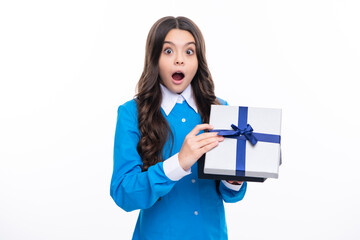 Wall Mural - Emotional teenager child hold gift on birthday. Funny kid girl holding gift boxes celebrating happy New Year or Christmas. Surprised emotions of young teenager girl.