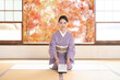 © kapinon - A woman in kimono sitting in seiza thanking for winter gifts and year-end gifts