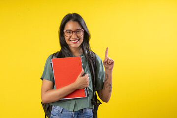 Wall Mural - Woman, young, student with backpack and notebooks in hand in studio photography