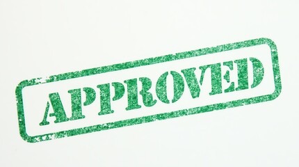 Green approved stamp on white paper background