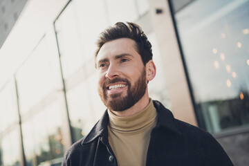 Poster - Portrait of handsome cheerful man dressed stylish clothes walking in megapolis city autumn day outdoors