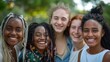 © P - A friendly group of young women from different races, all standing closely and smiling warmly