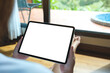 © Farknot Architect - Mockup image of a woman holding digital tablet with blank desktop screen at home