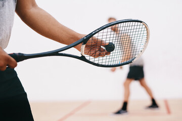 Wall Mural - Squash, man and racket serve on court, competition and team for indoor fitness or tournament. Male person, friends and gym for physical training or workout, practice sports and athletes for exercise