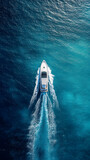 Aerial view of luxury motor boat. Speed boat on the azure sea in turquoise blue water - birdseye aerial view of boat. aerial view