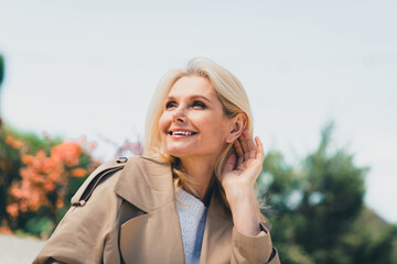 Sticker - Portrait of attractive senior female resting strolling enjoy weekend touch hair wondered charming wear beige coat pastime fresh air outdoor