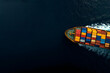© AungThurein - An aerial view of a massive cargo ship navigating through calm, deep blue ocean waters