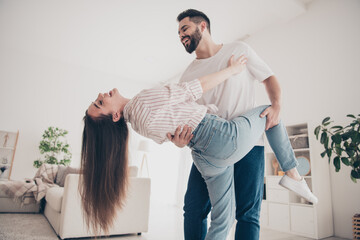 Canvas Print - Photo of happy young couple move place enjoy live together dancing have fun cuddle new apartment room light house flat indoor