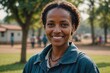 © ThomasLENNE - Close portrait of a smiling 40s Ethiopian woman looking at the camera, Ethiopian outdoors blurred background