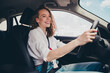 © deagreez - Photo of charming good mood woman wear white shirt driving auto going shopping outdoors urban city street