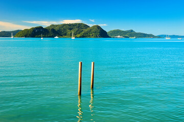 
A beautiful view of Langkawi island against a beautiful blue sky with  some boats in the distance on the horizon. Tropical scenery. located at Kedah, Malaysia - September  25  2024: