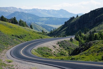 A winding asphalt road through the mountains, with sharp turns and elevation changes, offering a thrilling drive with scenic views.