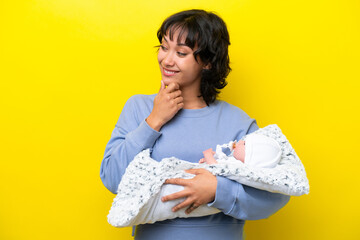 Wall Mural - Young Argentinian woman with her cute baby looking side