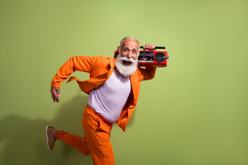 Sticker - Profile photo of funny extravagant man run empty space boombox wear orange suit isolated on green color background