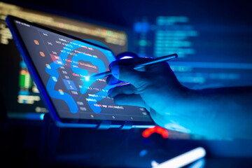 Wall Mural - programmer manually working with program code on a computer at night in a data center and technology