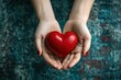 © Minerva Studio - Woman holding bright red heart in her hands