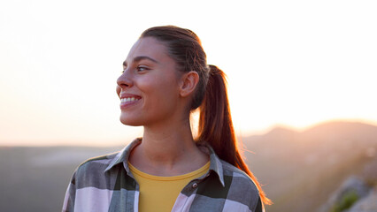 Young woman hiking and enjoying the mountain sunset