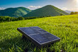 © Sync - Realistic outdoor solar cell electric power generate panel system in grass field ground with mountain and blue cloud sky background landscape in concept of eco power and sustainablility