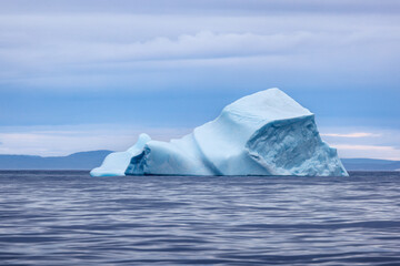 Wall Mural - blue iceberg in the cold, blue waters of the arctic ocean at bontekoe island, northeast greenland na