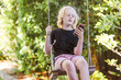 © Austockphoto - Pre-teen boy relaxing on backyard swing with mobile cell phone on a bright spring day