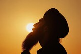 silhouette of a sikh person combing his long beard.