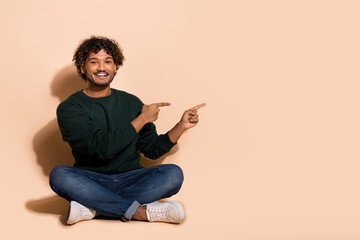 Sticker - Full size photo of nice young man indicate fingers empty space wear sweater isolated on beige color background