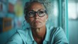 © svastix - A distinguished woman wearing glasses, with a confident gaze, is immersed in deep thought, symbolizing wisdom and introspection in a serene environment.