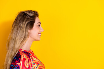 Poster - Side profile photo of young blonde hair charming woman wear colorful shirt looking empty blank space isolated on yellow color background