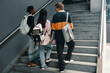 © DragonImages - Rear view of group of students walking up the stairs and talking, they going to lesson together