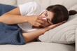 © New Africa - Woman with napkin suffering from sinusitis on sofa at home