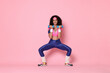 © New Africa - Woman doing aerobic exercise with dumbbells on pink background