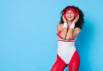 Canvas Print - Aerobics. Happy woman in headphones on light blue background, space for text