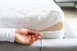 © brizmaker - Woman hand pull zip on the cover of mattress with foam filling