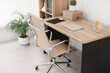 © New Africa - Beige leather chair, laptop and desk in office, above view