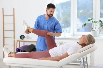 Sticker - Physiotherapist working with senior patient in rehabilitation center