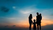 © JINGWEN - Happy family silhouette against stunning sunset sky,  beautiful nature landscape evoking family vacation concept.